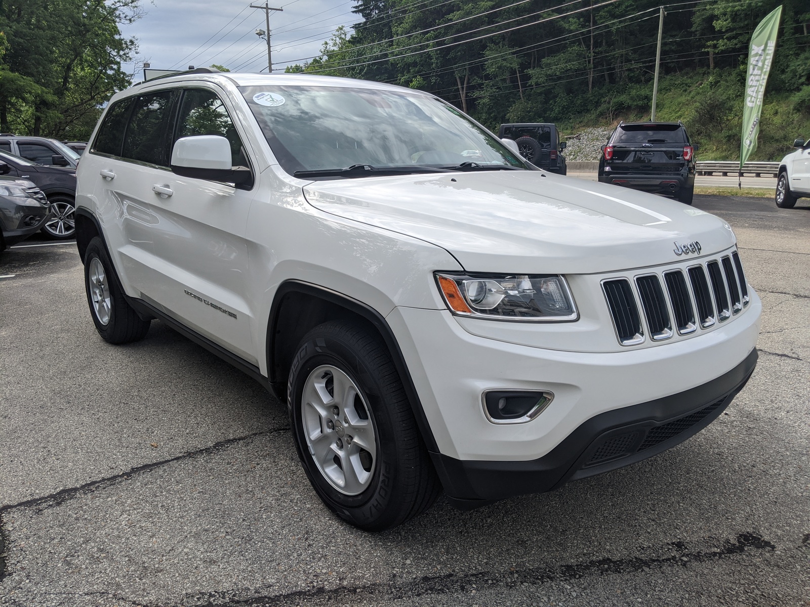 Pre-Owned 2014 Jeep Grand Cherokee Laredo in Bright White Clearcoat